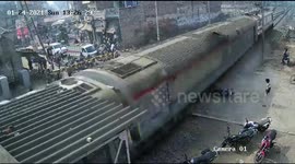 Speeding train in India narrowly misses biker but smashes his motorcycle