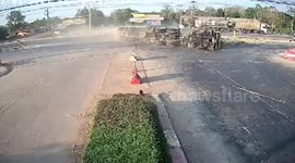 Overloaded truck topples over while turning tight corner