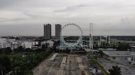 Drone flies through Ferris wheel at abandoned theme park in Bangkok