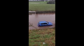 Car stranded in deep floodwater in wirral Merseyside UK. passenger rescued