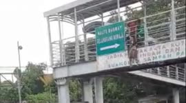 Rescue of a woman who wants to jump from a pedestrian bridge in East Jakarta, Indonesia