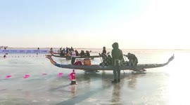 Dragon boat race held on frozen river in northern Chinese park