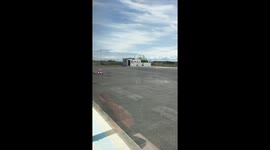 Small Cessna passenger plane taking off from runway in a field!