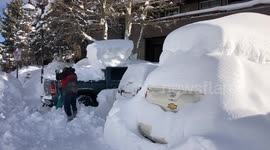 Resident of Mammoth Lakes clears snow away from his vehicle after a snowstorm