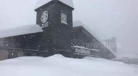 Heavy snow falls at a Starbucks during a snowstorm at Mammoth