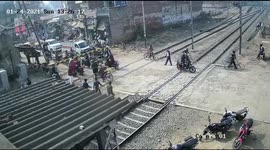 Lucky escape: Indian biker narrowly avoids being smashed by oncoming train