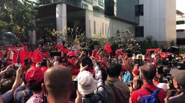 Protester stomps on picture of Myanmar military chief as dozens gather outside embassy in Bangkok