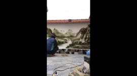 Vietnamese man paints beautiful landscape on wall