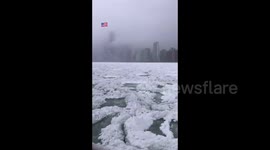Lake Michigan in Chicago covered in snow as major winter storm moves in