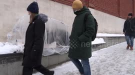 Self-made greenhouse keeps a homeless warm on the snow in Moscow winter