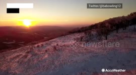 Soar above snow-capped Virginia mountains during a majestic sunrise