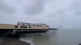 Starlings of Aberystwyth burst out from under The Royal Pier in Aberystwyth, West Wales, UK