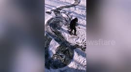 Chinese man carves incredibly detailed animals into surface of frozen river