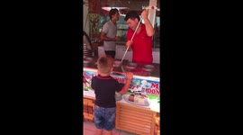 Cart Vendor Performs Tricks With Ice Cream While Serving A Little Kid