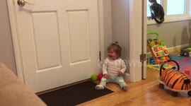 Cute little girl with a unique infectious laugh plays catch with her parents