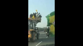 Protesting farmers take scary ride on excavator arms in northern India