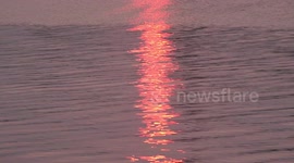 Fire on the water in a river in Thailand.