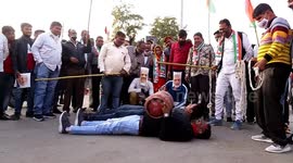 Congress activists wear face masks of Indian Prime Minister Narendra Modi to protest against fuel price hike