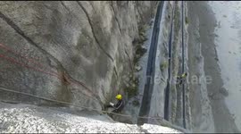 India glacier: Rescuers descend into valley by rope