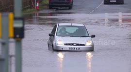 Elderly motorist tackles floods in a Yorkshire village.