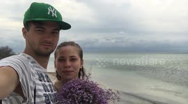 The guy and his girlfriend are together on a deserted island.