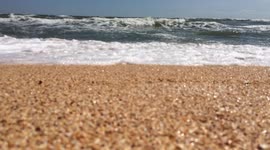 A bright sunny day. A seagull can be heard screaming. Waves of the Black Sea hit the coast of Dzharylgach Island. Dzharylgach is an island created by a goddess.