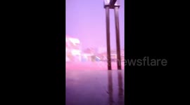 Moment spectacular lightning strike crashes down in front of residents amid flooding in Indonesia
