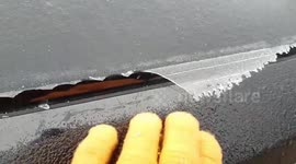 US: Arctic Blast Creates Glass-Like Ice Film On Car Window