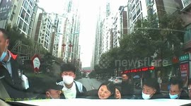 Chinese passersby lift car up together to free mother and son trapped underneath