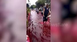 Blood-red flood swamps village in Indonesia
