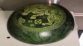 Laser used to engrave patterns into coconuts and watermelons ahead of Lunar New Year in Vietnam
