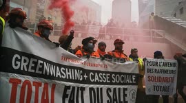 French workers protest over job cuts outside Total’s Paris HQ