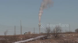 Optical illusion of smoke billowing from 5G LTE cell tower but closer inspection reveals it's cellular antennas attached to a vent stack from a renewable energy power plant in Markham Canada