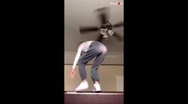 Girl Nearly Knocks Herself Out by Hitting her Head on Ceiling Fan