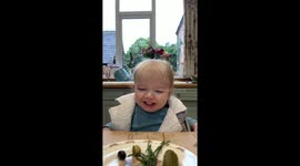 Baby Joe tries olives and pickles for the first time. He’s laughing but doesn’t like them.