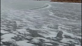 US: Drone Footage Of Frozen Pond In Edmond, Oklahoma