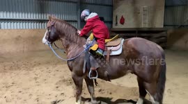 Impressive two-year-old girl rides and trots her horse all by herself