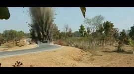 Debris hurled 40 feet into the air as Indian police detonate two bombs under road