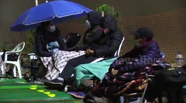 Residents sleep outdoors as they queue for oxygen in Peru