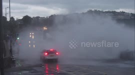Large Wave Strikes Cars