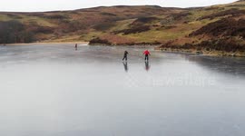 Friends enjoy a socially distanced skate on a frozen lake 1