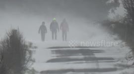 Family Doing Lock Down Walk In Blizzard