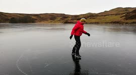 Ice skating on a frozen lake in The Lake District England
