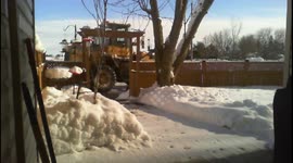 Loader Clearing Snow On a Bright Winters Day