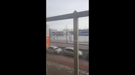 Dutch person walks with bike on frozen canal