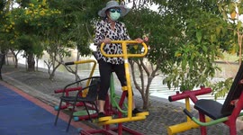 A couple having a great laugh while exercising in a park on St. Valentines Day.