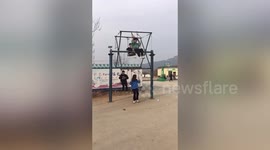 Villagers have fun on ferris-wheel-liked swing in central China