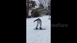 US: Man Snowboards Down Street In Little Rock, Arkansas