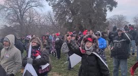 Members of crowd express discontent with officers securing United States capitol.