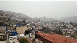 Rare scene as snow begins in fall in Jerusalem